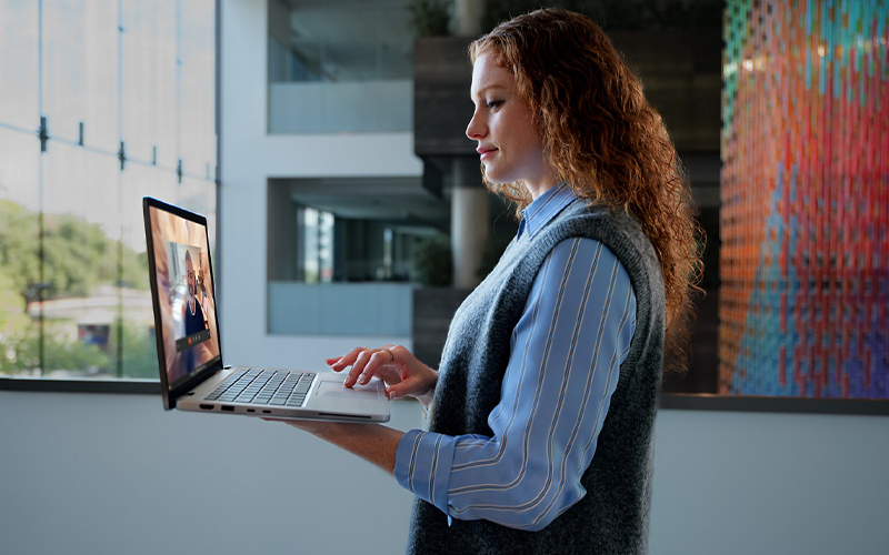 Delight your workforce woman using laptop while standing