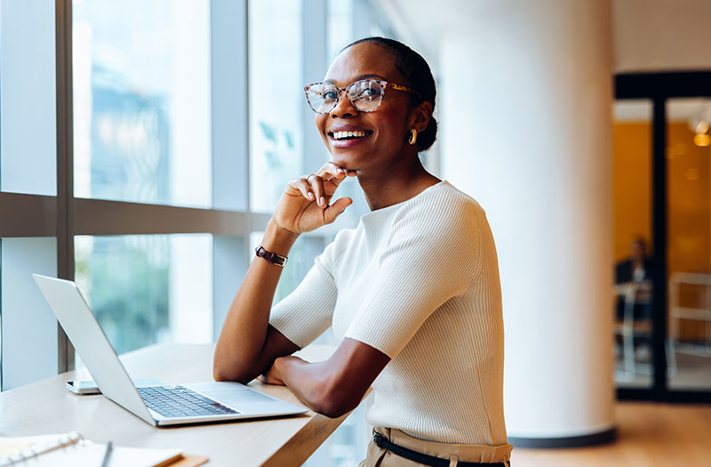 Woman working on laptop smiling