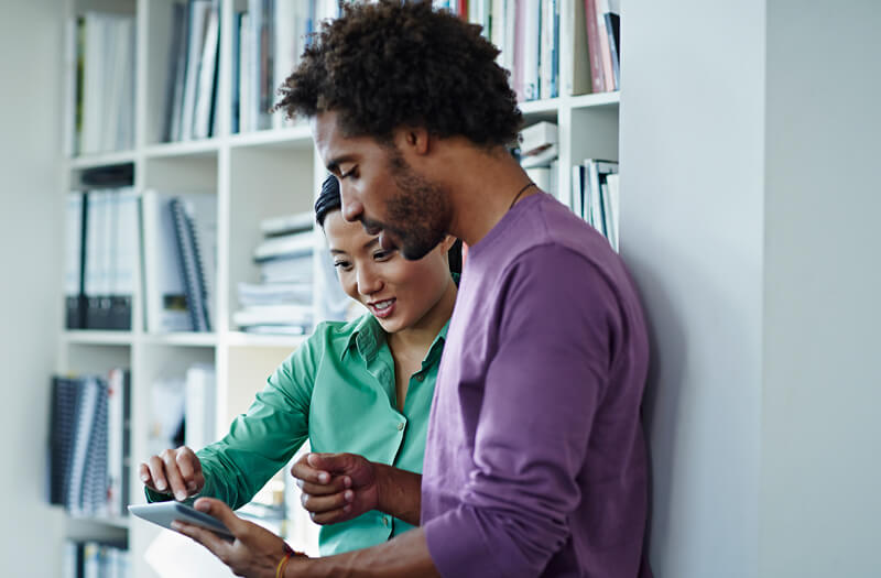 Business professional reviewing regulatory compliance information on computer.