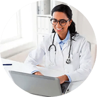 A doctor working using a laptop