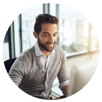 Man looking at desktop while smiling