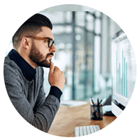 Serious business man reviewing billing data on desktop computer