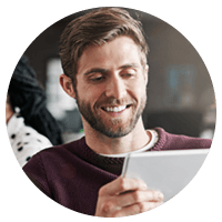 Man smiling holding tablet