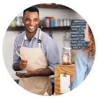 Smiling cafe owner is able to work efficiently with new technology