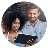 Small business owner interacts with customer using tablet device