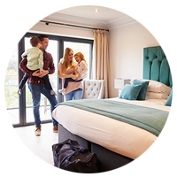 Family arriving in hotel room on vacation