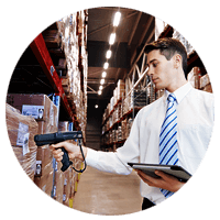 Employee checks inventory with barcode scanner and tablet in distribution center