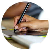 User using a stylus on a tablet to draw
