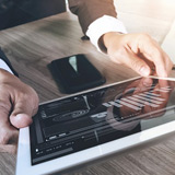 Enterprise mobility management Close up of business professional using mobile device management software on tablet computer