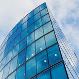 Infrastructure as a Service (IaaS) Modern office building with clouds reflected in windows
