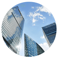 Ants eye view of building skyline with sky and clouds in foreground and background