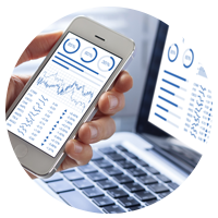 Laptop and smartphone displaying financial charts.