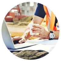 Construction worker with hard hat checking smart phone.