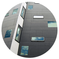 Clouds reflected on multiple windows of a modern business