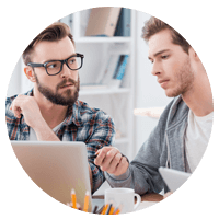 Two business men looking over laptop computer