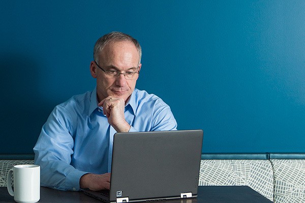 IT executive using notebook computer remotely to lookup company information