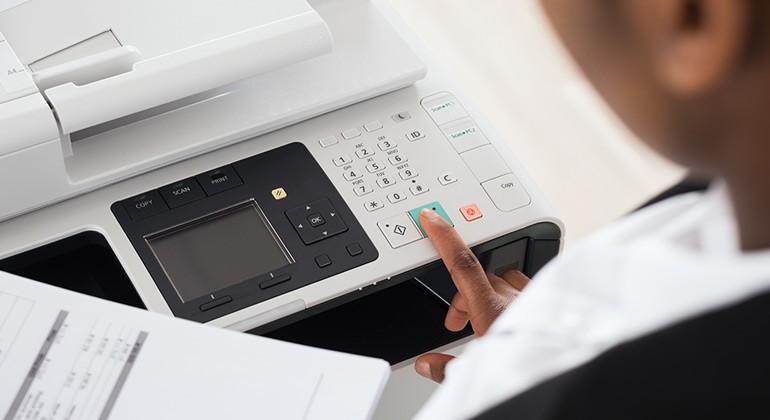 Comprehensive internal audit of printing equipment Business woman using multifunction printer in office