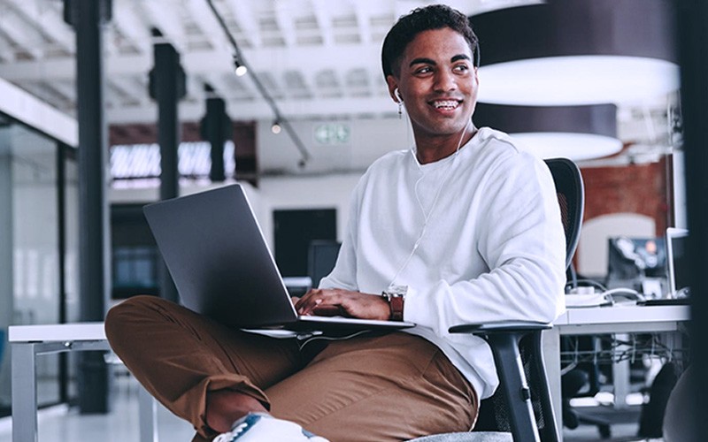 Man looking somewhere else while using laptop
