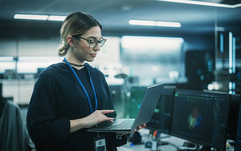 Are you looking to complete your hybrid cloud? woman using laptop while standing
