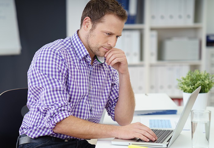 Business manager on laptop computer using Cisco Meraki Systems Manager