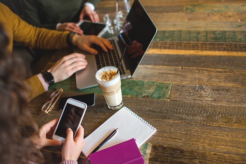 Team using multiple mobile devices while working remotely