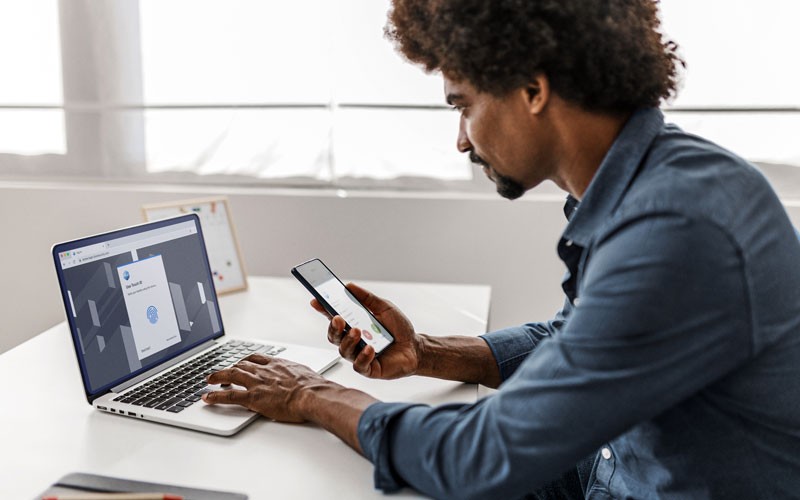 man using laptop and phone