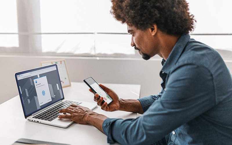 male using laptop and phone