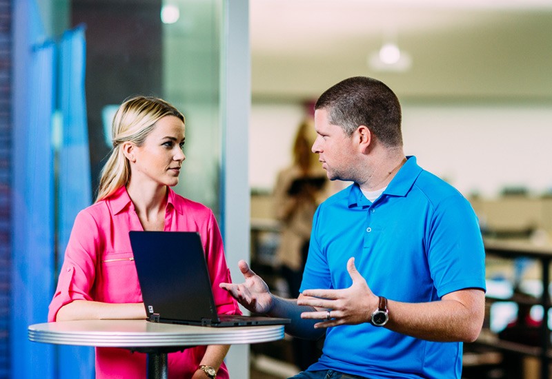 Business professionals review information found on a desktop computer