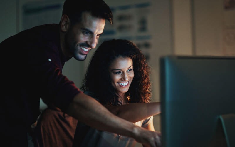 Two users working on monitor