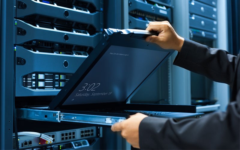 Dell EMC security services Dell employee in server room about to use laptop