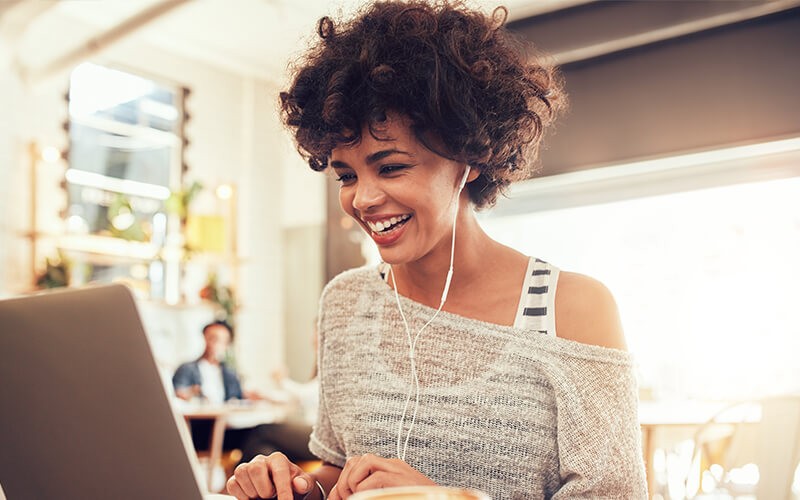 Happy woman using chromebook