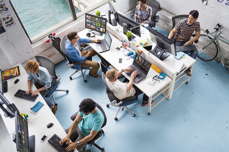 Powerful processing for maximum productivity Overhead view of creative professionals working in an office with various HP workstations and displays.
