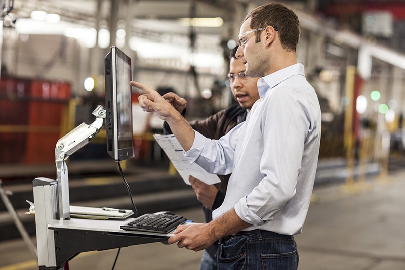 Workers using the HP EliteOne 800 23” AIO in manufacturing facility