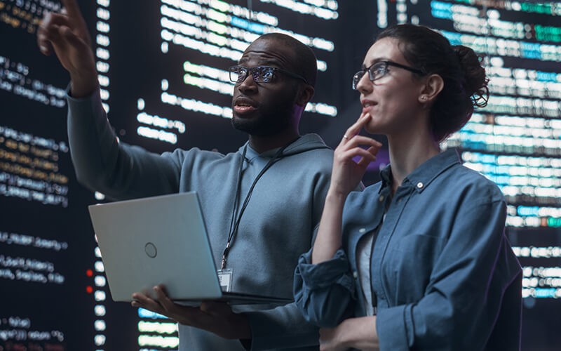 Professionals using laptop inside data center