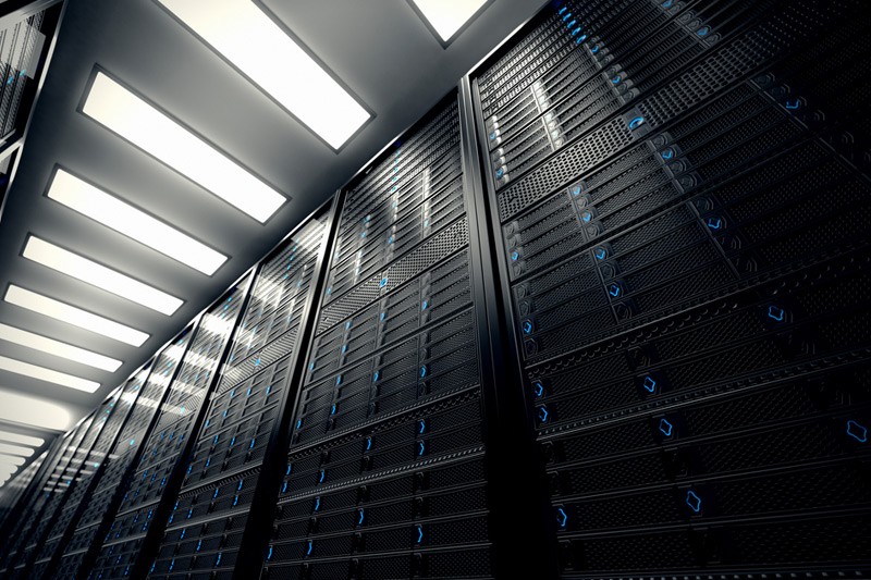Worms eye view of server room servers with blue lights.