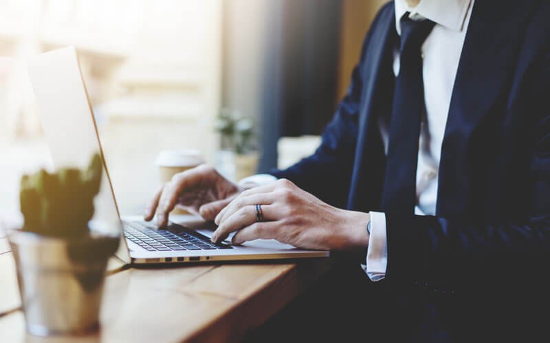 Young business professional typing on computer 