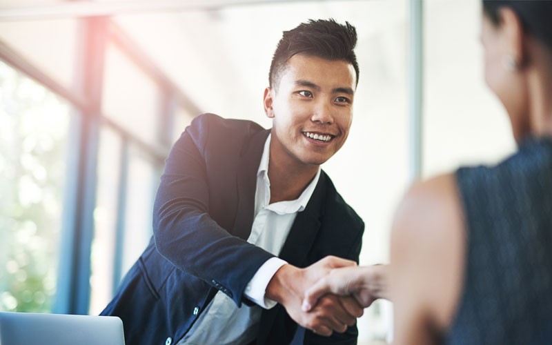 Business man reaching out for handshake