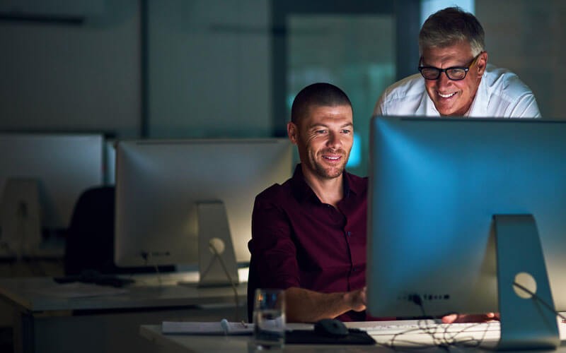 Two men working on computer