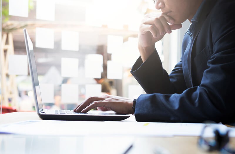 investor-reviewing-data-off-laptop-screen