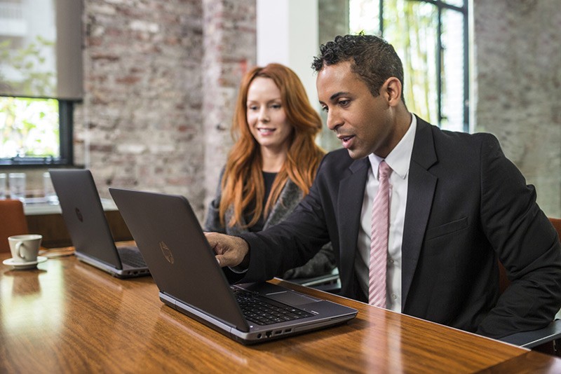 Superior reliability for workplace collaboration Professionals working on the HP ProBook 640 and 650 in a conference room