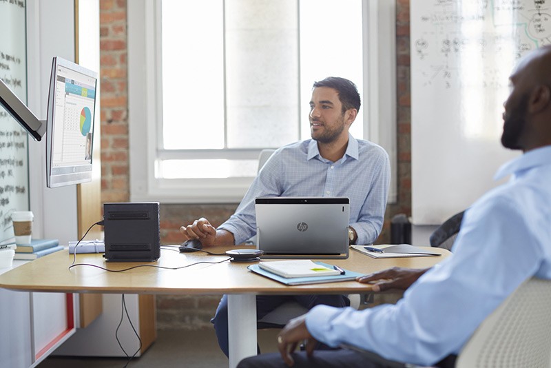 Affordable, flexible option for workers who need maximum versatility Two men using a HP Collaboration PC G2 with a HP Elite x2 1012 G1, EliteDisplay 240c and HP EliteDesk 800 65W G2 – DM 65W, while working together.