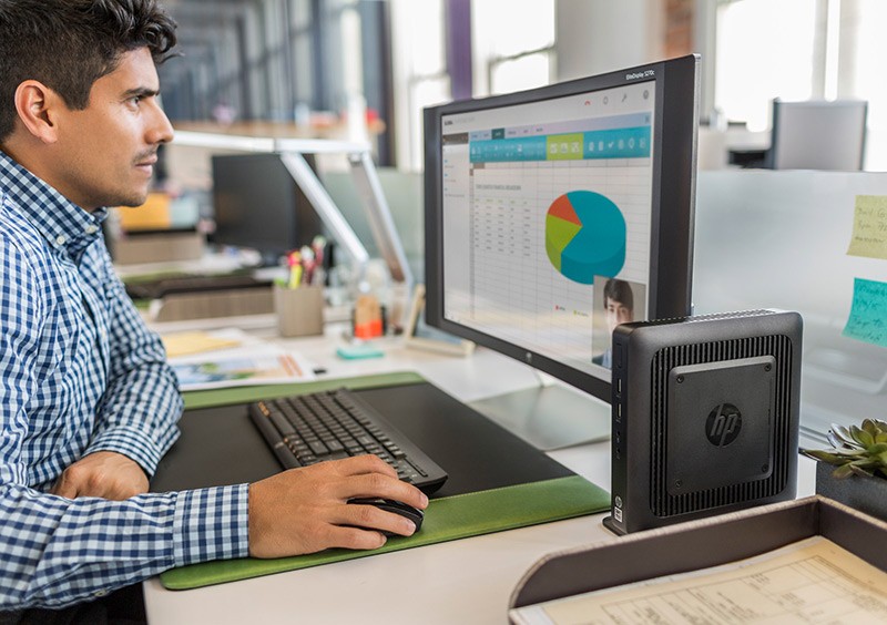 The support you need Business professional working on a HP S270c curved display and a HP t520 Flexible Thin Client