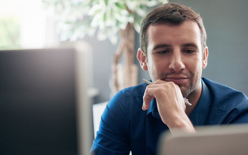 Enterprise applications your business can count on Business man looking at desktop screen