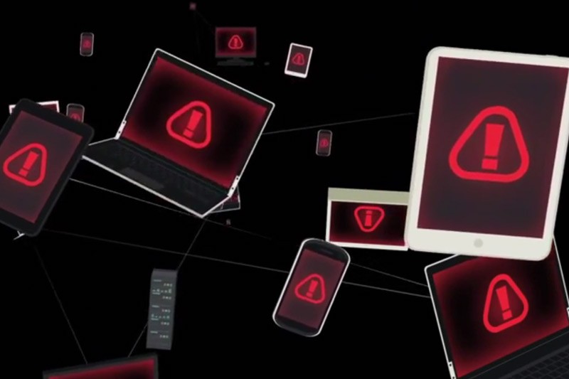 Unbeatable network threat protection Abstract image of connected devices with warning symbols on the screen.
