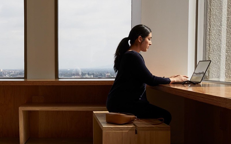 microsoft-surface-woman-working-on-wood-table