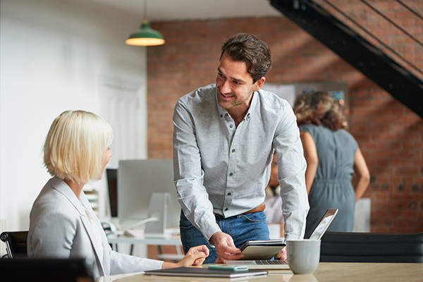 cloud-communications-office Man and woman collaborating on a tablet