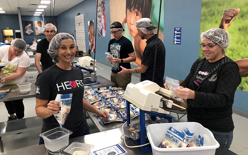 Insight teammates participate in packing food for Feed the Starving Children non-profit