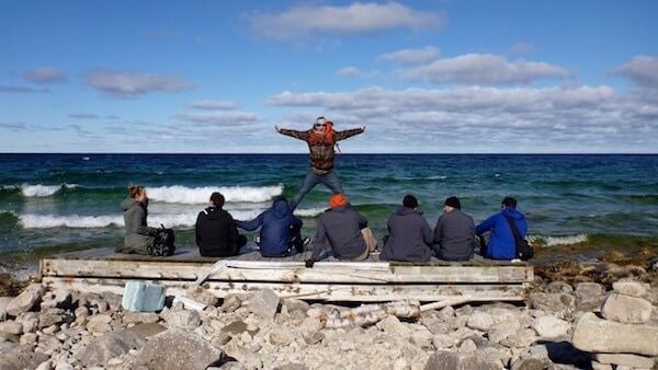 Insight Australia team celebrates on the coast of a beach