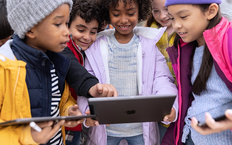 students holding ipad