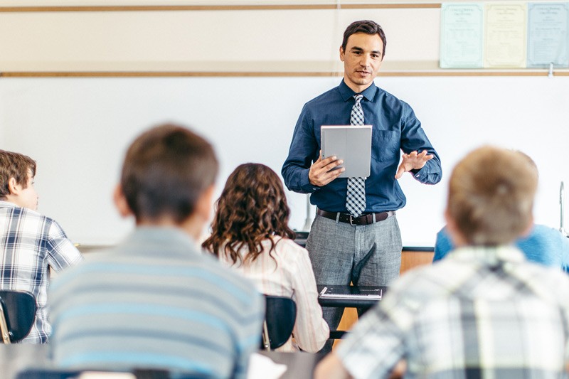 Teacher with tablet leading a science class
